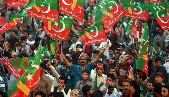 PTI supporters wave flags during a protest in this undated image. — Reuters/File