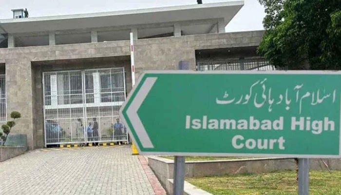 A billboard pointing towards the Islamabad High Court. — APP/File