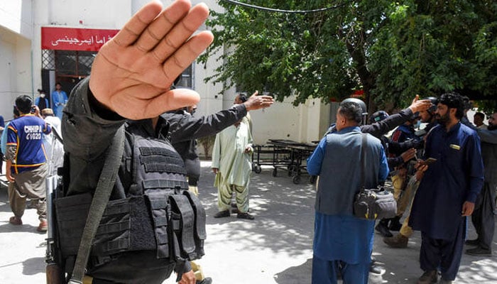 Policemen impede the media as injured security personnel arrive at a hospital in Quetta, following a bomb explosion of a police bus in Mastung district, Pakistan, on April 15, 2025. —AFP/File