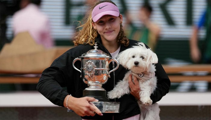 Mirra Andreeva celebrates her French Open title with her coach Conchita Martinezs dog. —AFP