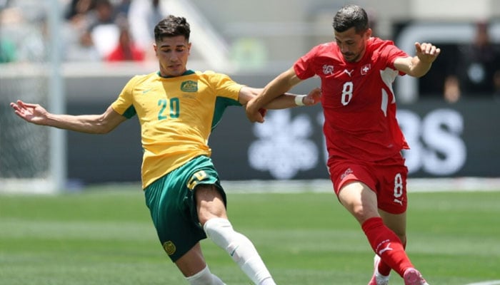 Australias Cristian Volpato (left) in action on his debut against Switzerland after switching allegiance from Itlay on the eve of the World Cup. —AFP