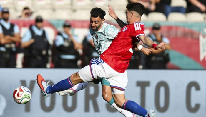 Bruno Fernandes (left) tries to beat a block from Chiles Agustin Arce. —AFP