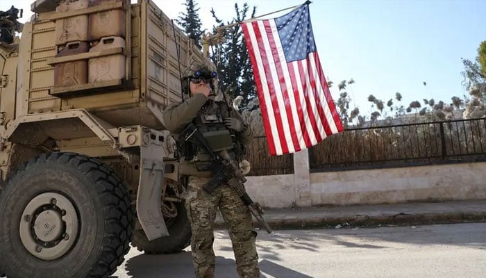 US soldier stands guard during a meeting between Syrian Democratic Forces (SDF) leaders and US military leaders, in Deir Hafer, Syria, on January 16, 2026. —Reuters