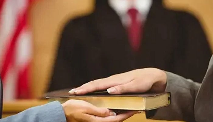 A representational image shows a person taking an oath. — Unsplash/File