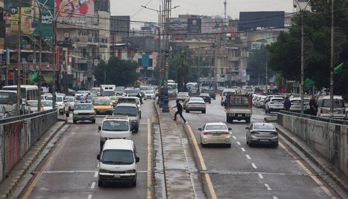 Vehicles are driven on the road following rainfall in Baghdad, April 28, 2026. —AFP