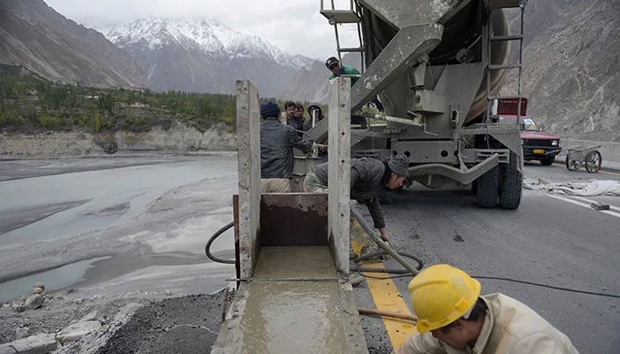 Labourers work on the Karakoram highway in Gulmit village of Hunza valley.— AFP/File