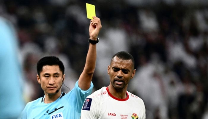 Chinese referee Ma Ning shows a yellow card at the Asian Cup. —AFP/File