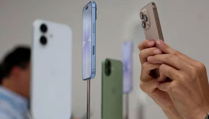 A person uses a phone in a shop. — Reuters/File