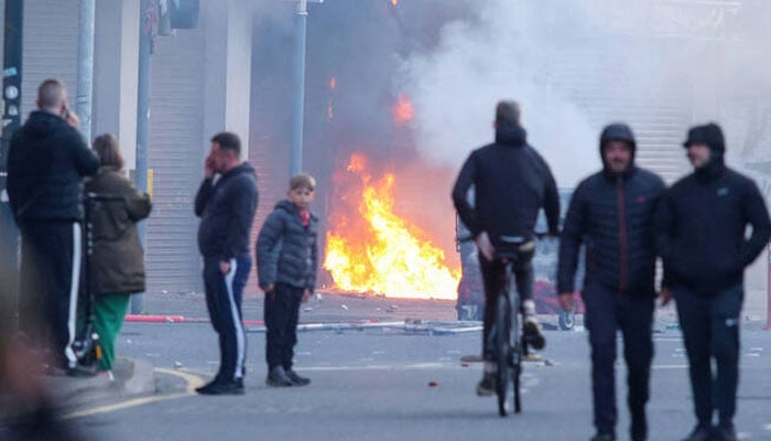 A building is set alight in the Sandy Row area of Belfast city centre, Northern Ireland, in the evening of June 9, 2026. —AFP