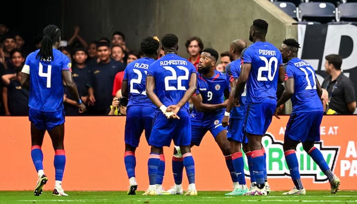 Haiti forward Duckens Nazon (9) celebrates with teammates after his goal during the first half against Qatar at NRG Stadium.—Reuters