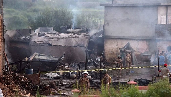 Rescue teams of the Pakistan Army are present at the crash site on July 30, 2019. — AFP