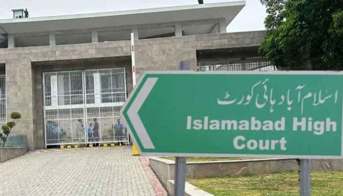 A billboard pointing towards the Islamabad High Court. — APP/File