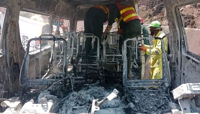 Rescue workers inspect the burnt-out tourist van involved in the deadly crash near Khajut on Islamabad-Murree Expressway, Murree, June 10, 2026. — Reporter/Duaa Mirza