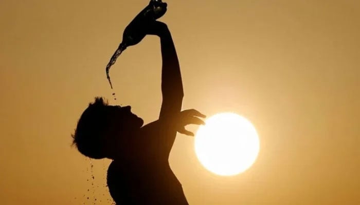 A runner cools down with water in Skopje, North Macedonia July 12, 2023. — Reuters