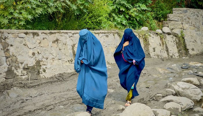 Afghan women in burqa walk towards a safer place after their house was damaged following a deadly magnitude 6 earthquake that struck Afghanistan on Sunday, at Lulam village, in Nurgal district, Kunar province, Afghanistan, on September 3, 2025. — Reuters