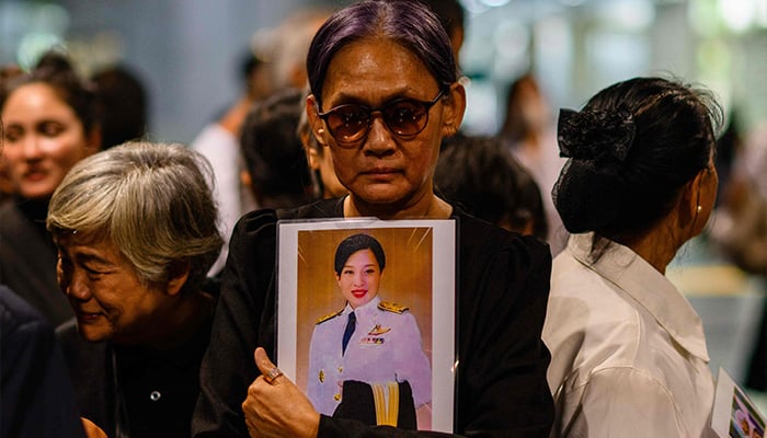 Mourners hold photos of Thai Princess Bajrakitiyabha Mahidol inside Chulalongkorn Hospital in Bangkok on June 12, 2026. — AFP