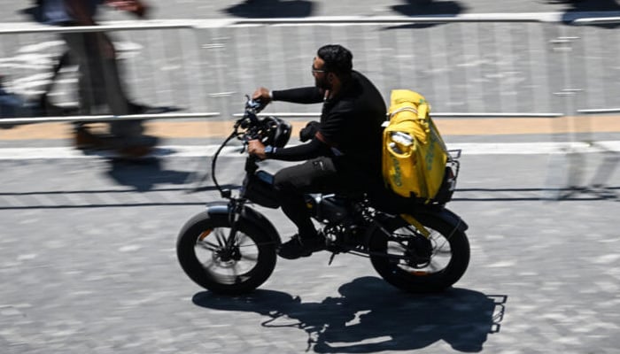 The agreement covers hundreds of millions of people worldwide working through digital platforms, in areas such as food delivery. — AFP/File