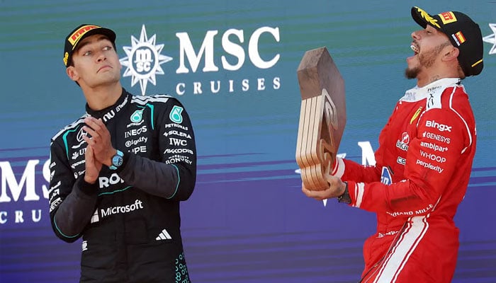 Ferrari’s Lewis Hamilton (right) and Mercedes’ George Russell celebrate at the podium after the Barcelona-Catalunya Grand Prix. —AFP