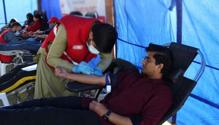This image shows a healthcare professional getting a blood sample for blood donation on December 20, 2023. — Facebook@PakistanRedCrescent