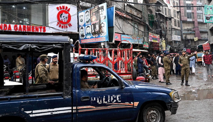 Police personnel patrol a market in Lahore on November 10, 2023, during a four-day lockdown imposed by the provincial Punjab government to tackle acute smog conditions. —AFP