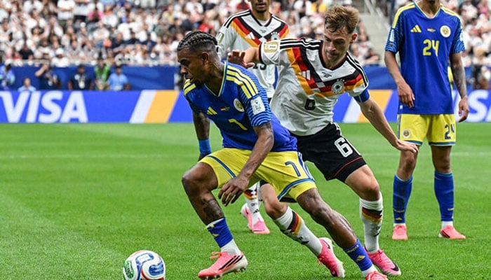 Curacaoan midfielder Juninho Bacuna (left) fights for the ball with German defender Joshua Kimmich in a World Cup Group E football match at Houston Stadium in Houston, Texas on June 14, 2026.— AFP
