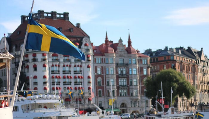 A Swedish flag flutters in front of residential houses in Stockholm, Sweden, September 14, 2023.—Reuters