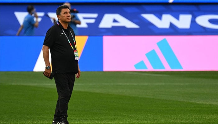 Irans head coach Amir Ghalenoei walks around the pitch after the press conference at Los Angeles Stadium in Inglewood on June 14, 2026, on the eve of the 2026 World Cup football match between Iran and New Zealand.—AFP
