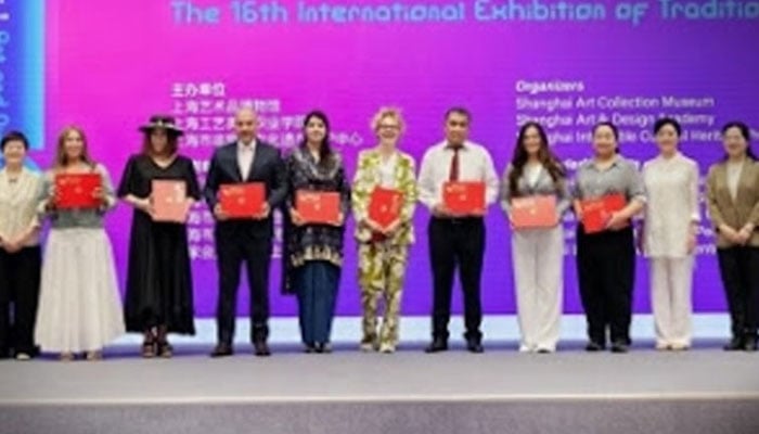 Participants pose for a group photo in this image. — INP/File