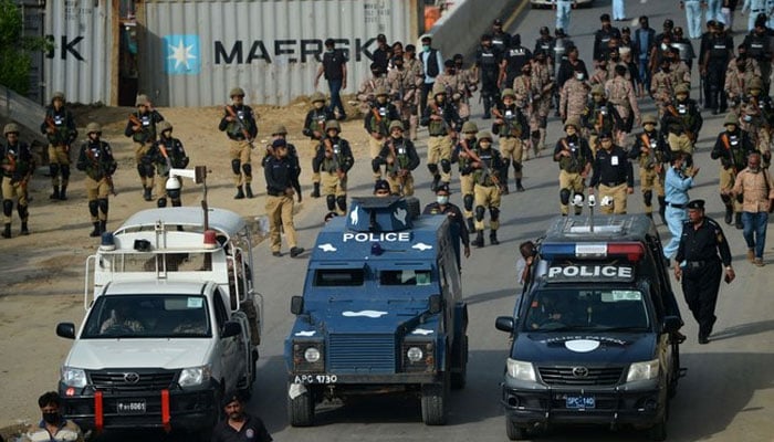 Security personnel patrol a street during a procession of Ashura in the Islamic month of Muharram in Karachi. — AFP/File