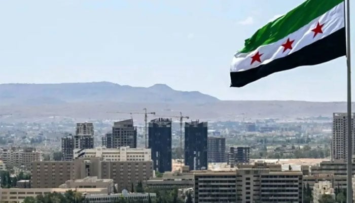 A large Syrian flag flutters above Tishreen Park in Damascus, June 4, 2025. —AFP