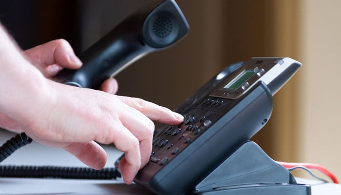This representational image shows a person using a landline office phone. — Pixabay/File