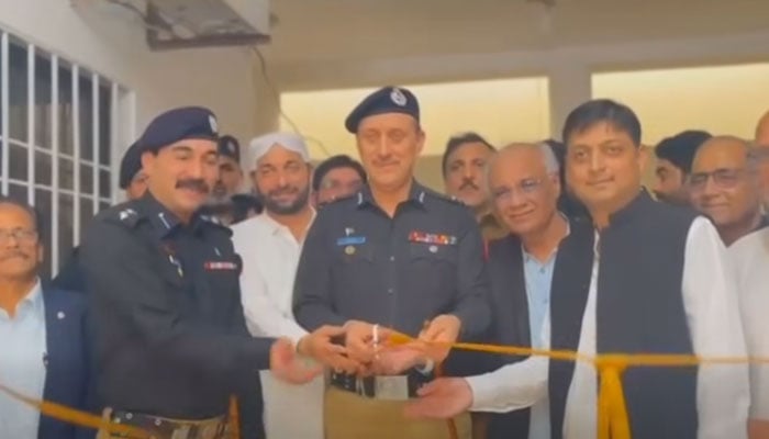 Additional Inspector General Karachi Azad Khan cuts a ribbon to inaugurate a modern command and control room equipped with 105 surveillance cameras at the Gulshan-e-Maymar police station on June 18, 2026. — Screengrab via Facebook@KarachiPoliceOfficial