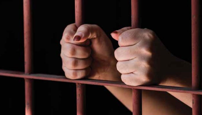This representational image shows a female inmate behind jail bars. — mohr.gov.pk/File