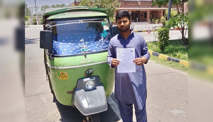 In this image, a rickshaw driver holding a freshly issued license next to an auto-rickshaw in the provisional capital on June 14, 2026. — Facebook@citytraffic.policelhr