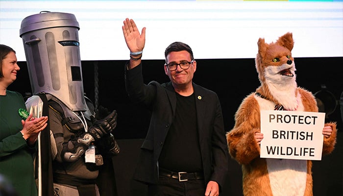 Labour candidate Andy Burnham waves to the crowd after Burnham wins the election for MP of Makerfield, at the count centre venue, the Edge in Wigan, northwest England on June 19, 2026. — AFP