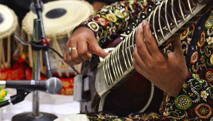 This representational image shows a man playing a musical instrument. — Unsplash