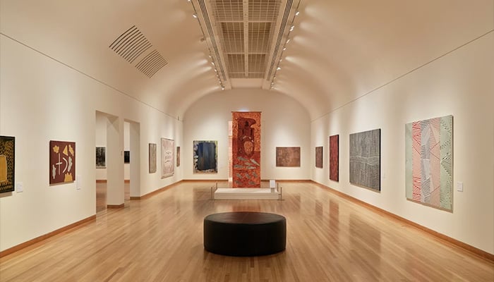 Representational image shows a room filled with paintings displayed on the walls. — Unsplash