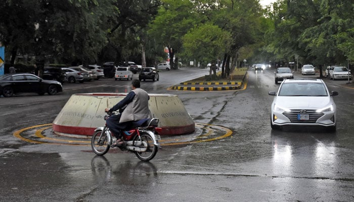 Motorists on a road during light rain in the Federal Capital on June 21, 2026. — Online