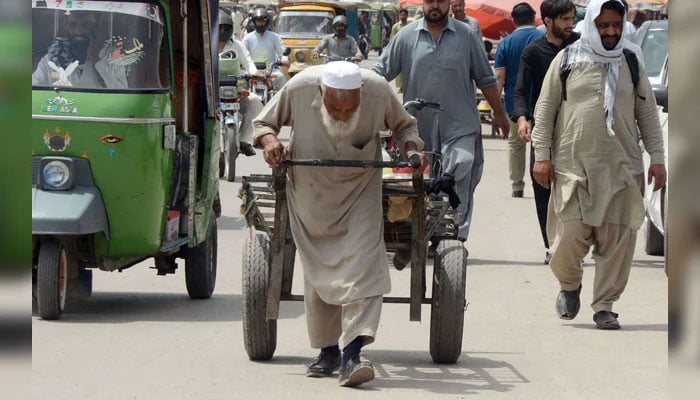 An elderly labourer is pulling a handcart at Murree road in Rawalpindi on May 31, 2026. — Online