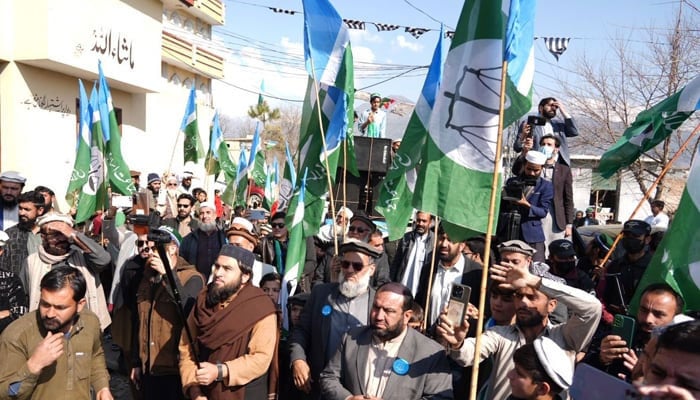 Jamaat-e-Islami (JI) supporters and workers hold party flags in KP on February 6, 2024. — Facebook@Siraj ul Haq