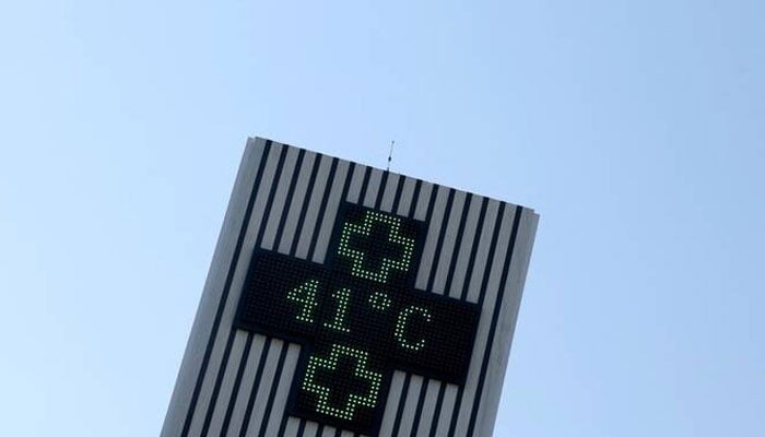 This photograph shows a pharmacy sign displaying a temperature of 41 degrees Celsius in Creon, near Bordeaux, south-western France, on June 17, 2026. —AFP