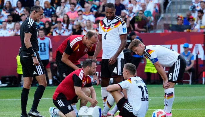 Germanys Nico Schlotterbeck receives medical attention after sustaining an injury, June 20, 2026. —Reuters