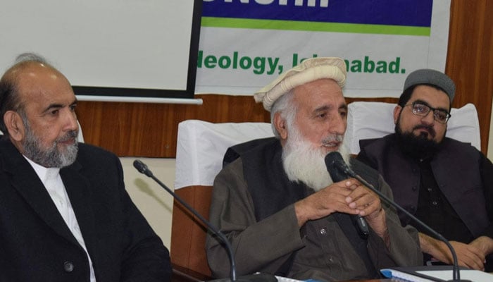 Chairman of the Pak Council of World Religions Qari Roohullah Madani (centre) speaks during an event. — Facebook@PCWRFF/File