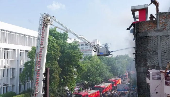 Firefighters douse a deadly fire at a coaching centre in Lucknow, India on June 22, 2026. — Reuters