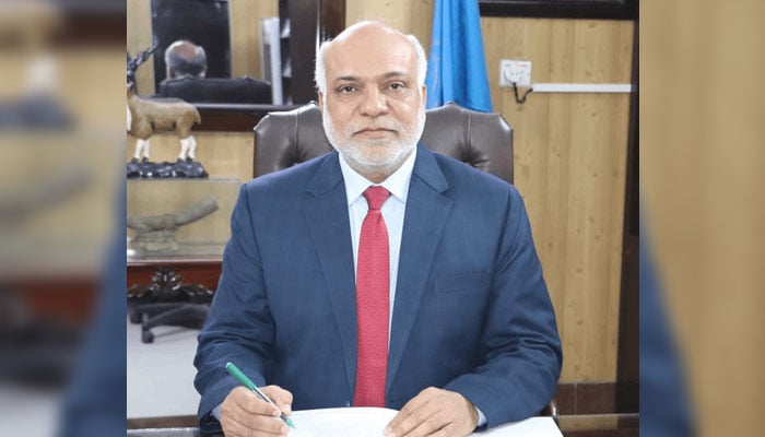 Gomal University Vice Chancellor Professor Dr Zafar Iqbal looks on in this image as he writes something on official documents. — http://gu.edu.pk/File