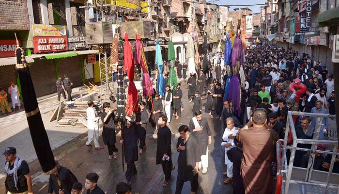 A large number of mourners participate in the Muharram procession passing through Qissa Khawani Bazaar on June 23, 2026. — APP