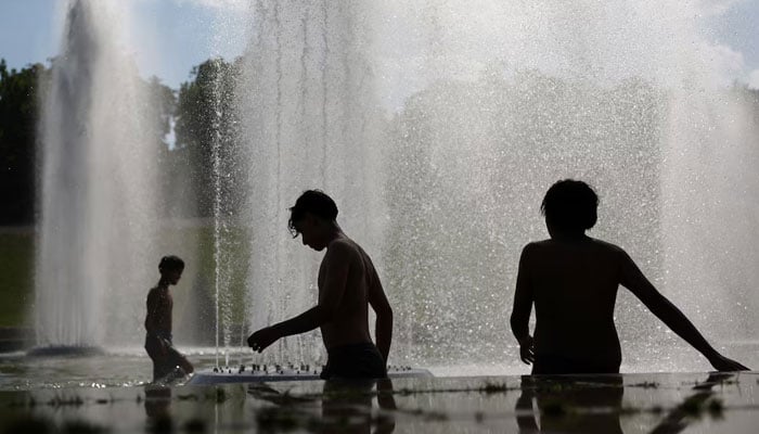 Children cool off in the Trocadero Fountain next to the Eiffel Tower in Paris as temperatures rise during a heatwave affecting a large part of France, June 22, 2026.—Reuters