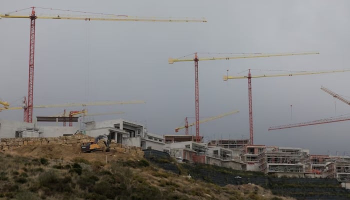 Cranes are seen over houses under construction of La Finca de Jasmine, a residential project of luxury villas with clubhouse and spa, in Benahavis, Spain, November 6, 2024. — Reuters