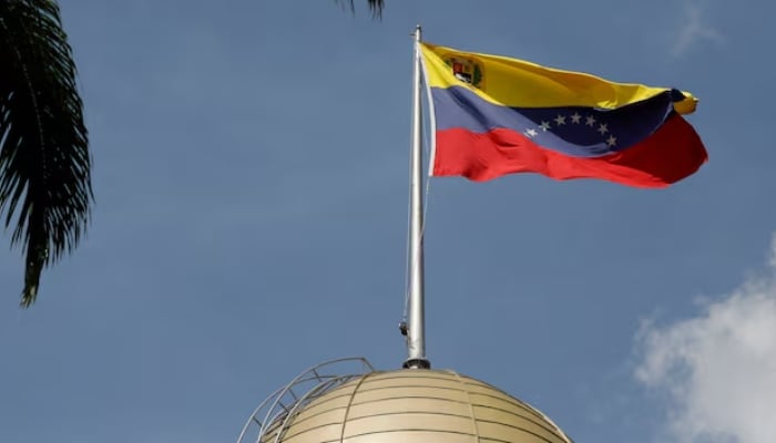 The Venezuelan flag flies atop the National Assembly, January 5, 2026. — Reuters
