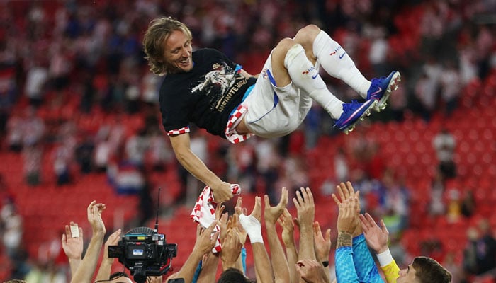 Croatias midfielder #10 Luka Modric is lifted up by his teammates as they celebrate after winning the 2026 World Cup Group L football match between Panama and Croatia at the Toronto Stadium in Toronto on June 23, 2026. — AFP